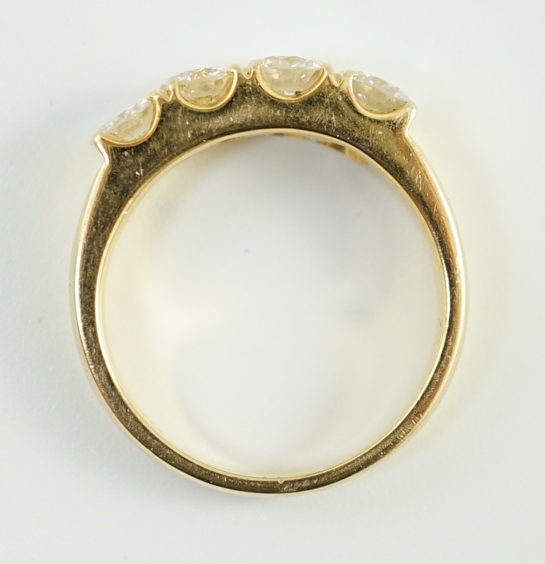A modern 750 gold and four stone diamond set ring